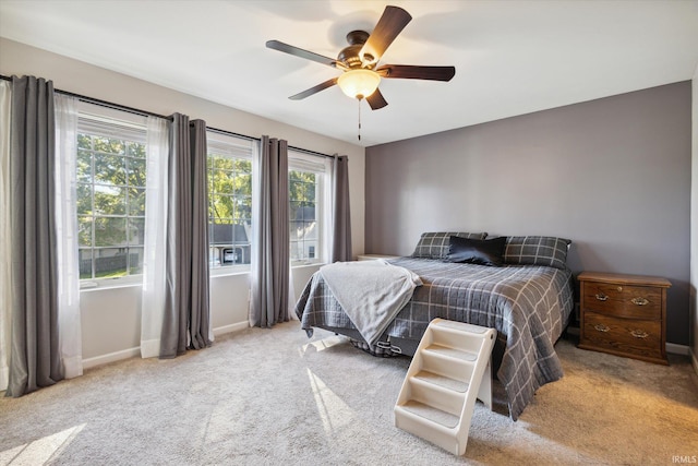 bedroom with light colored carpet and ceiling fan