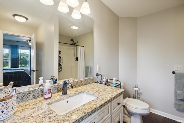 bathroom featuring ceiling fan, walk in shower, toilet, vanity, and tile patterned floors