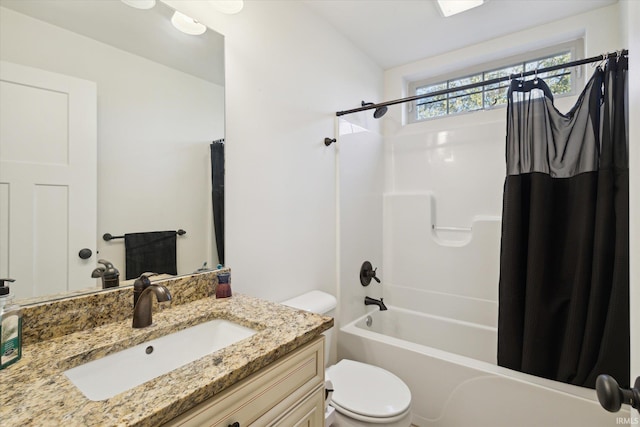 full bathroom featuring vanity, shower / bath combo, and toilet