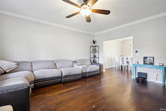 living room with crown molding, dark hardwood / wood-style flooring, and ceiling fan