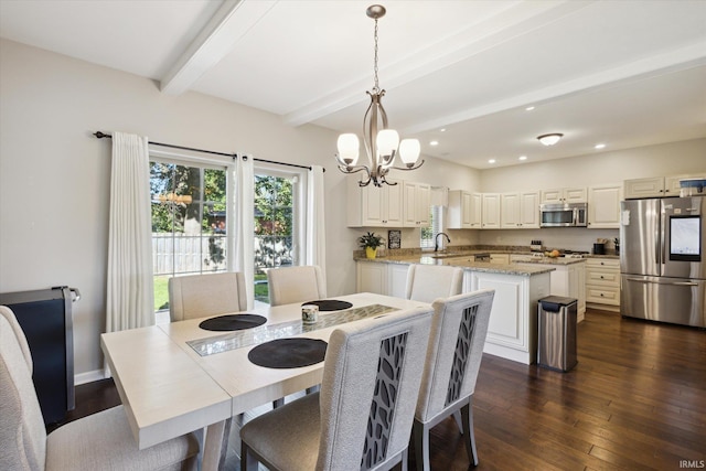 dining space featuring dark wood-type flooring, beam ceiling, a notable chandelier, and sink