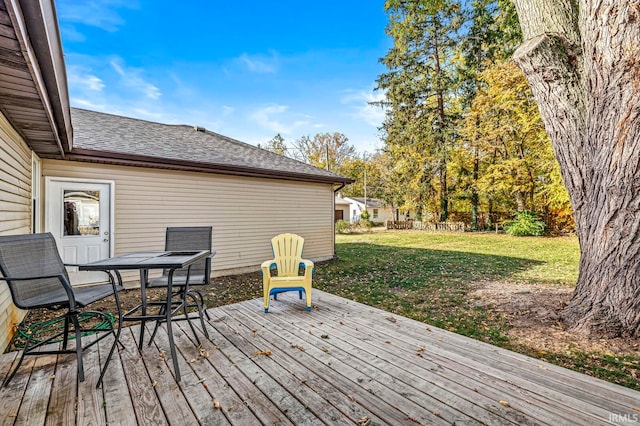 wooden terrace with a yard