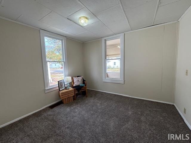 unfurnished room featuring dark colored carpet