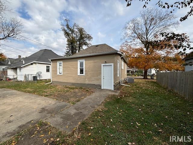 rear view of property with a lawn