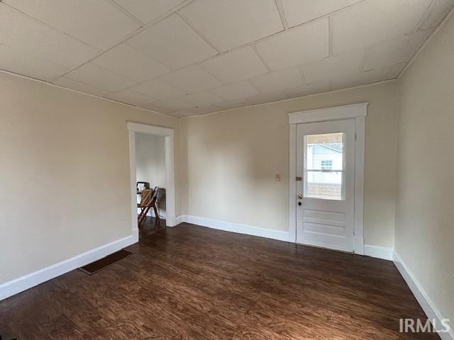 unfurnished room featuring dark hardwood / wood-style flooring