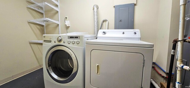 clothes washing area with electric panel and washer and clothes dryer