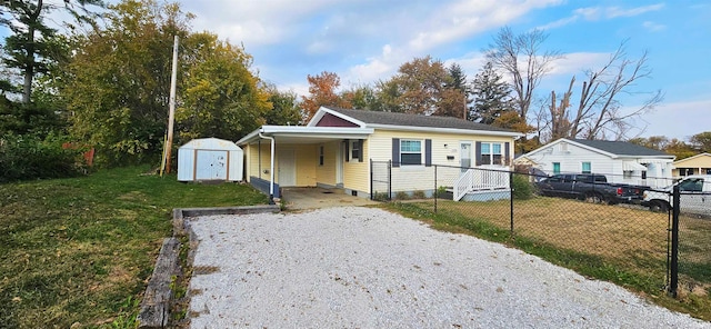 bungalow featuring a storage shed, a front lawn, and a carport