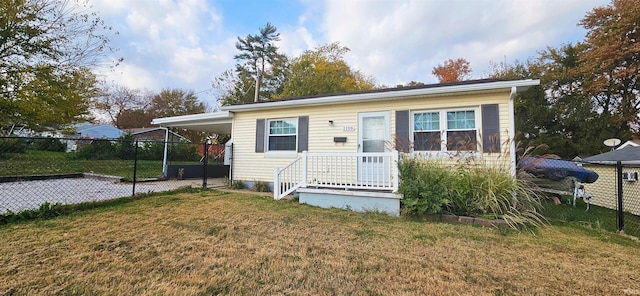 view of front of house with a front yard and a carport