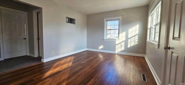 spare room featuring dark hardwood / wood-style floors