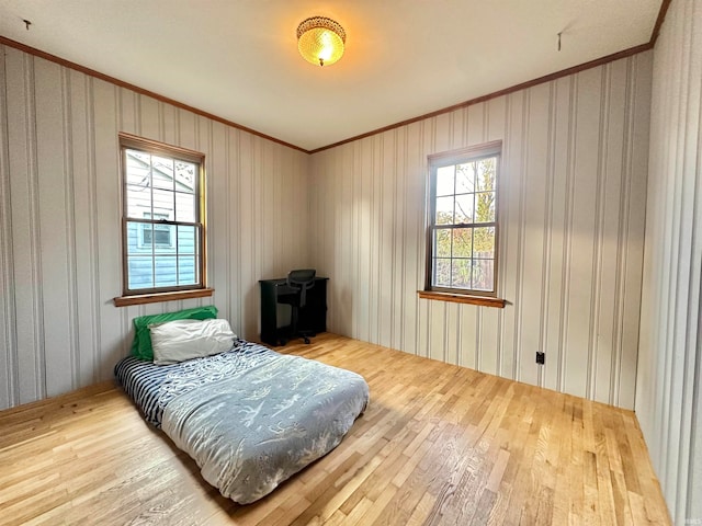 bedroom featuring hardwood / wood-style flooring and ornamental molding