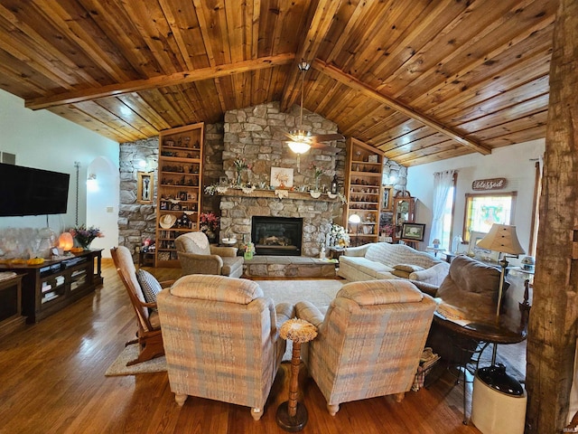 living room with wood ceiling, a stone fireplace, vaulted ceiling with beams, and dark hardwood / wood-style floors