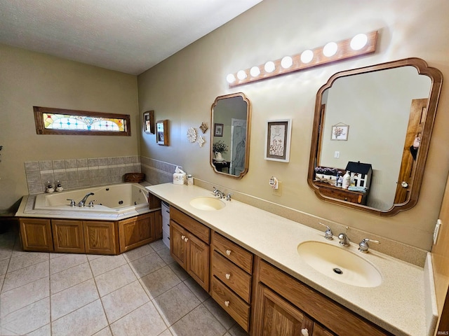 bathroom with vanity, a bathtub, a textured ceiling, and tile patterned floors