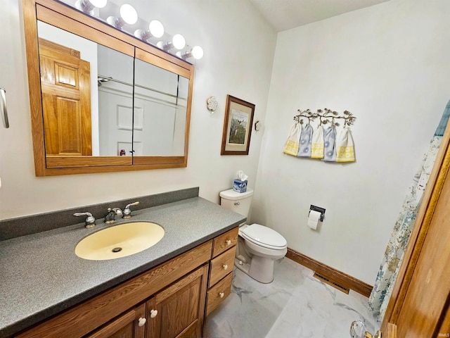 bathroom with toilet and vanity