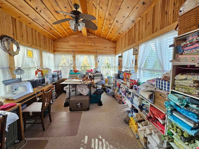 interior space featuring ceiling fan, wooden ceiling, lofted ceiling, wooden walls, and carpet