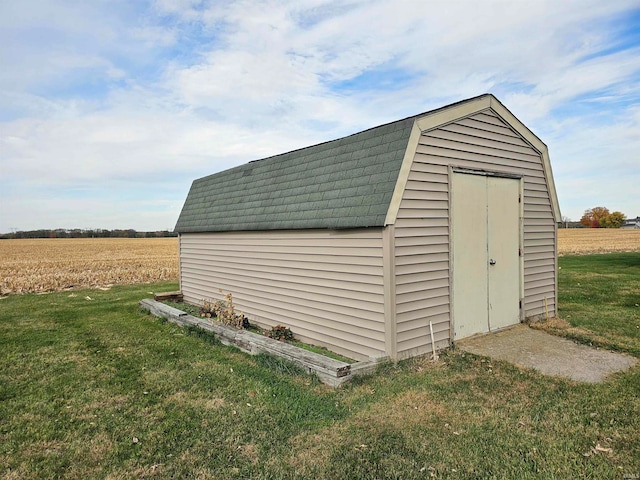 view of outdoor structure featuring a yard and a rural view