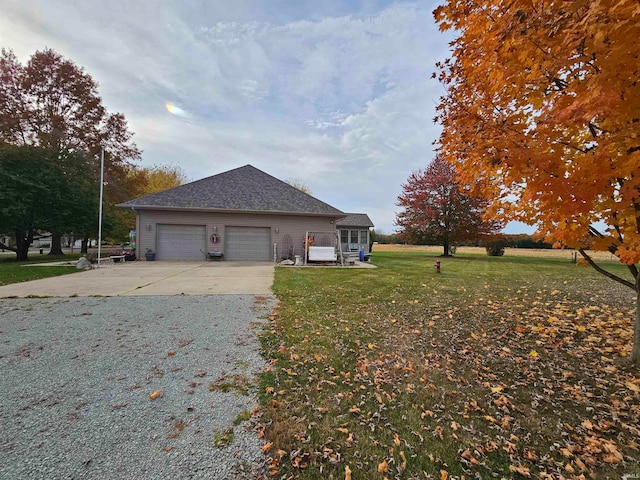 view of property exterior with a yard and a garage