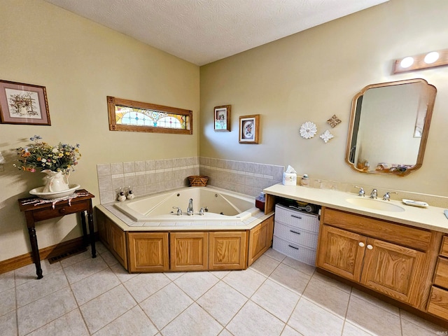 bathroom featuring vanity, a tub to relax in, a textured ceiling, and tile patterned floors