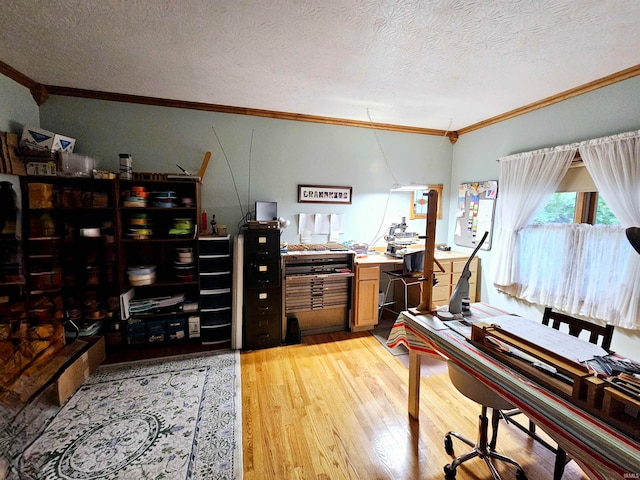 office space featuring a textured ceiling, ornamental molding, and light hardwood / wood-style flooring