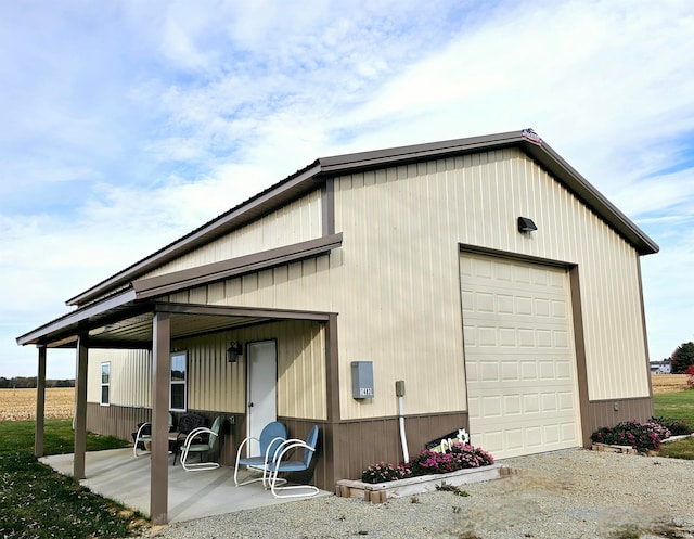 exterior space featuring a garage and an outbuilding