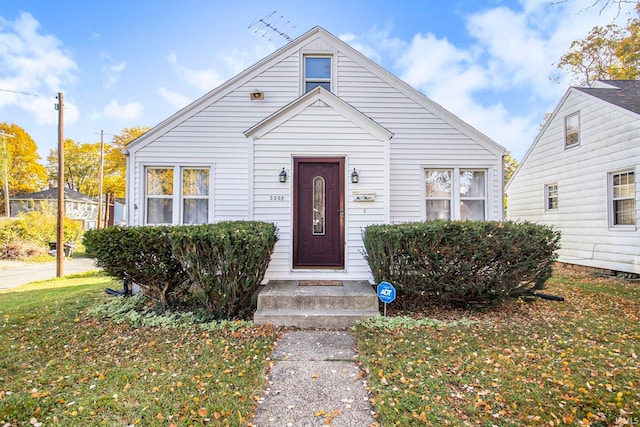 bungalow-style home featuring a front yard