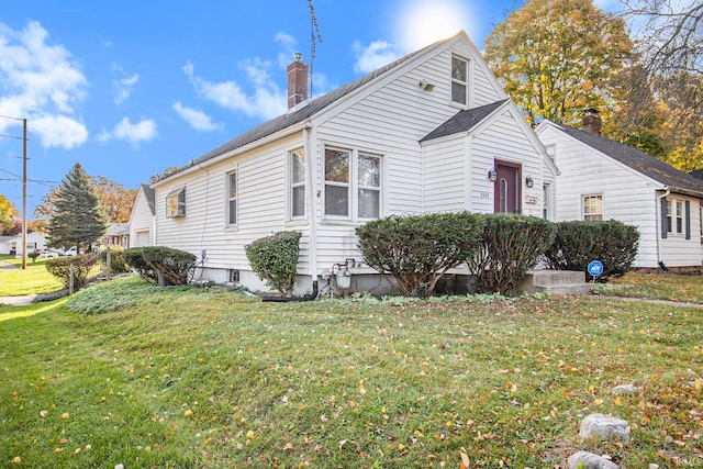 view of side of home with a lawn