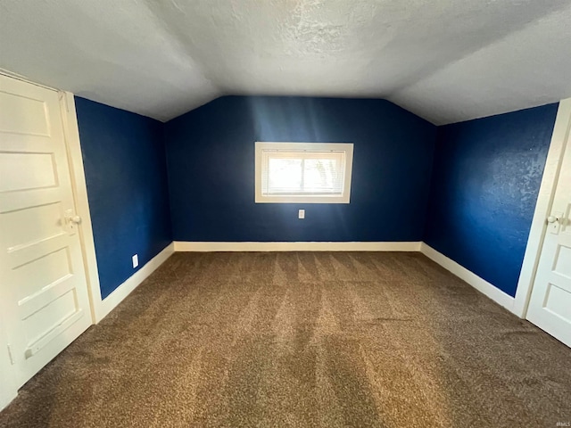 bonus room with a textured ceiling, carpet, and vaulted ceiling