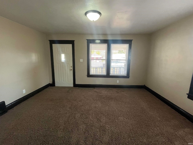 empty room with dark carpet