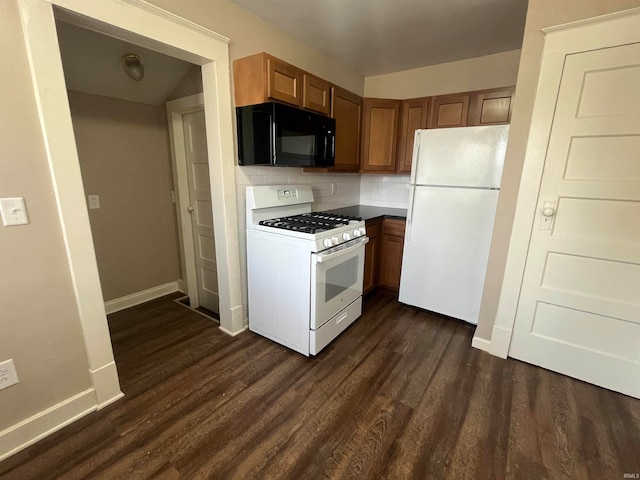 kitchen with dark hardwood / wood-style flooring, backsplash, and white appliances