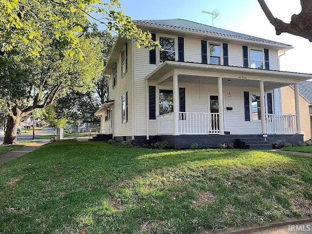 view of front of property with a front yard and covered porch