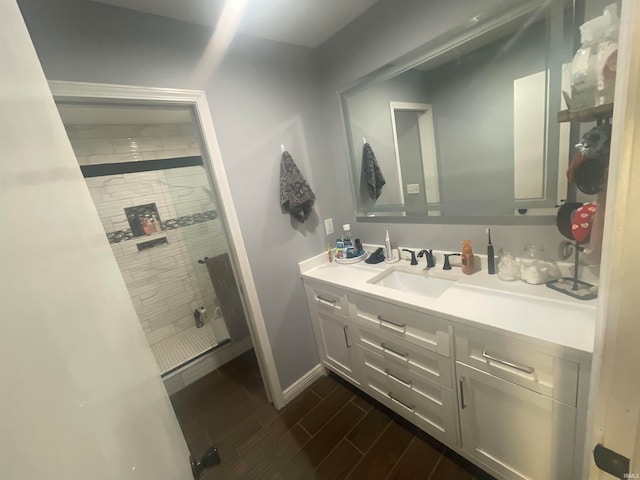 bathroom featuring vanity and tiled shower