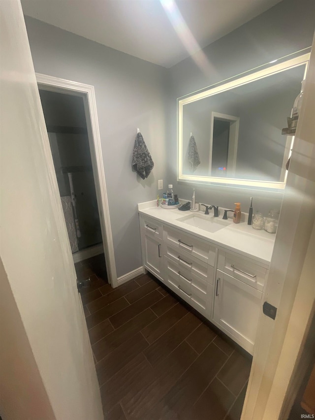 bathroom featuring vanity and hardwood / wood-style flooring