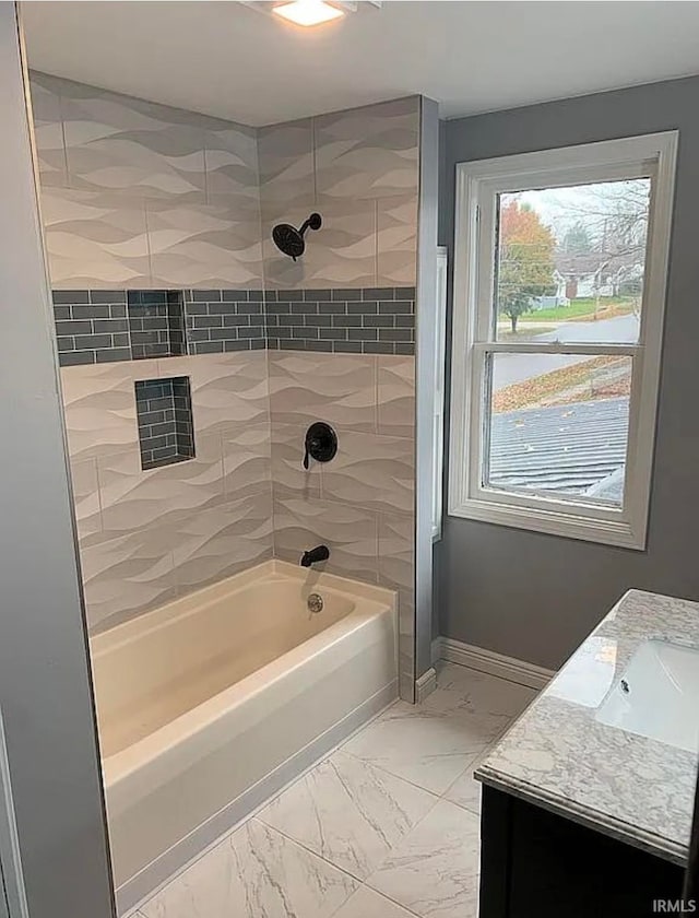 bathroom with vanity and tiled shower / bath combo