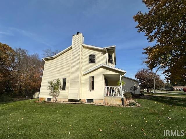 view of side of home featuring a yard