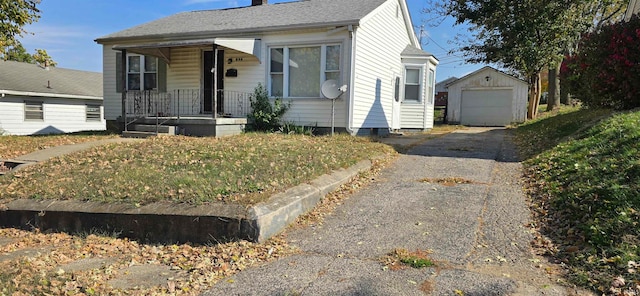 view of front of home with an outbuilding, a garage, and covered porch