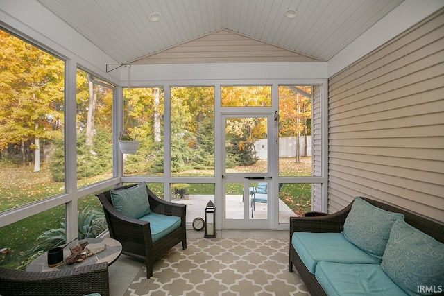 sunroom / solarium featuring lofted ceiling, a healthy amount of sunlight, and wooden ceiling