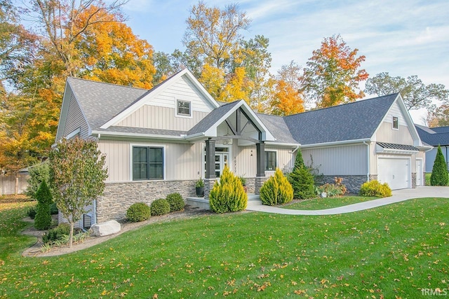 view of front of property with a front yard and a garage