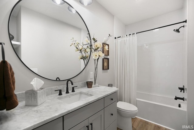 full bathroom with vanity, hardwood / wood-style flooring, toilet, and shower / bathtub combination with curtain