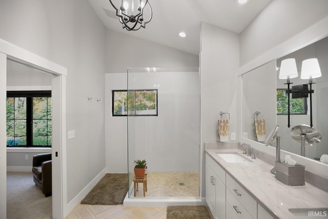 bathroom featuring vanity, vaulted ceiling, a notable chandelier, and walk in shower