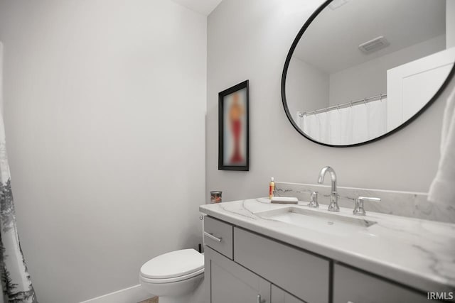 bathroom featuring vanity and toilet