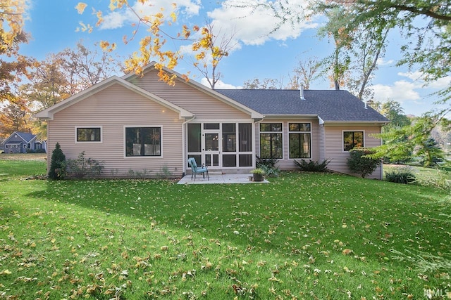 rear view of property with a yard, a patio area, and a sunroom