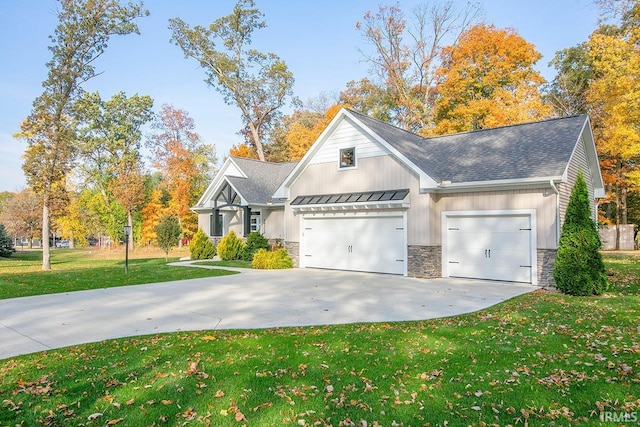 view of front of house with a garage and a front lawn