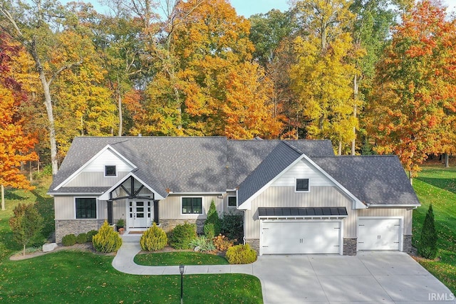 view of front of home with a front yard and a garage