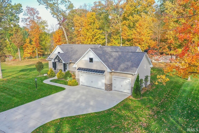 view of front of property with a garage and a front lawn