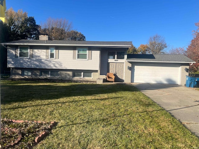 raised ranch featuring a front yard and a garage