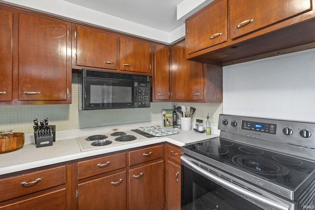 kitchen with tasteful backsplash, electric range, and white cooktop