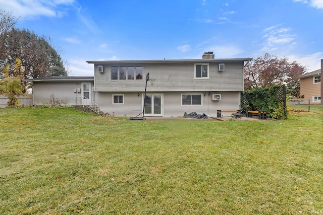 rear view of house with a yard and a patio area