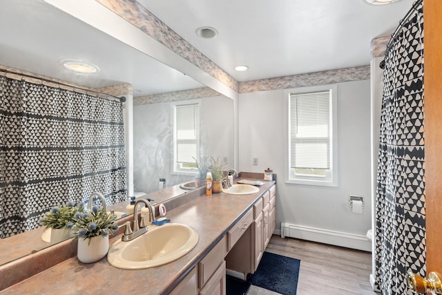 bathroom with a baseboard radiator, hardwood / wood-style flooring, toilet, vanity, and a shower with curtain