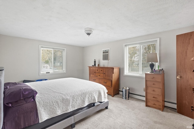 bedroom with a textured ceiling, baseboard heating, and light colored carpet