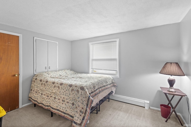 carpeted bedroom featuring a textured ceiling and baseboard heating