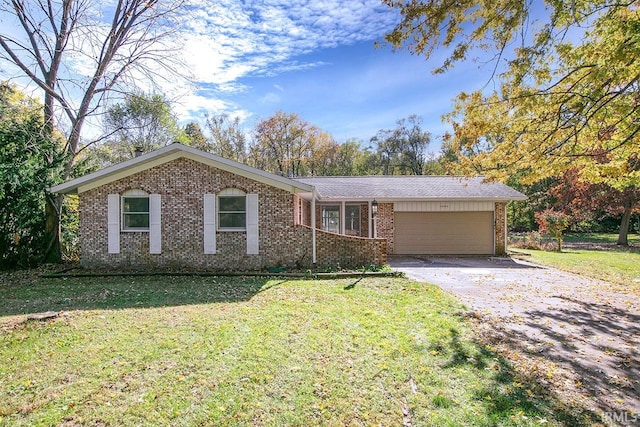 single story home with a front yard and a garage